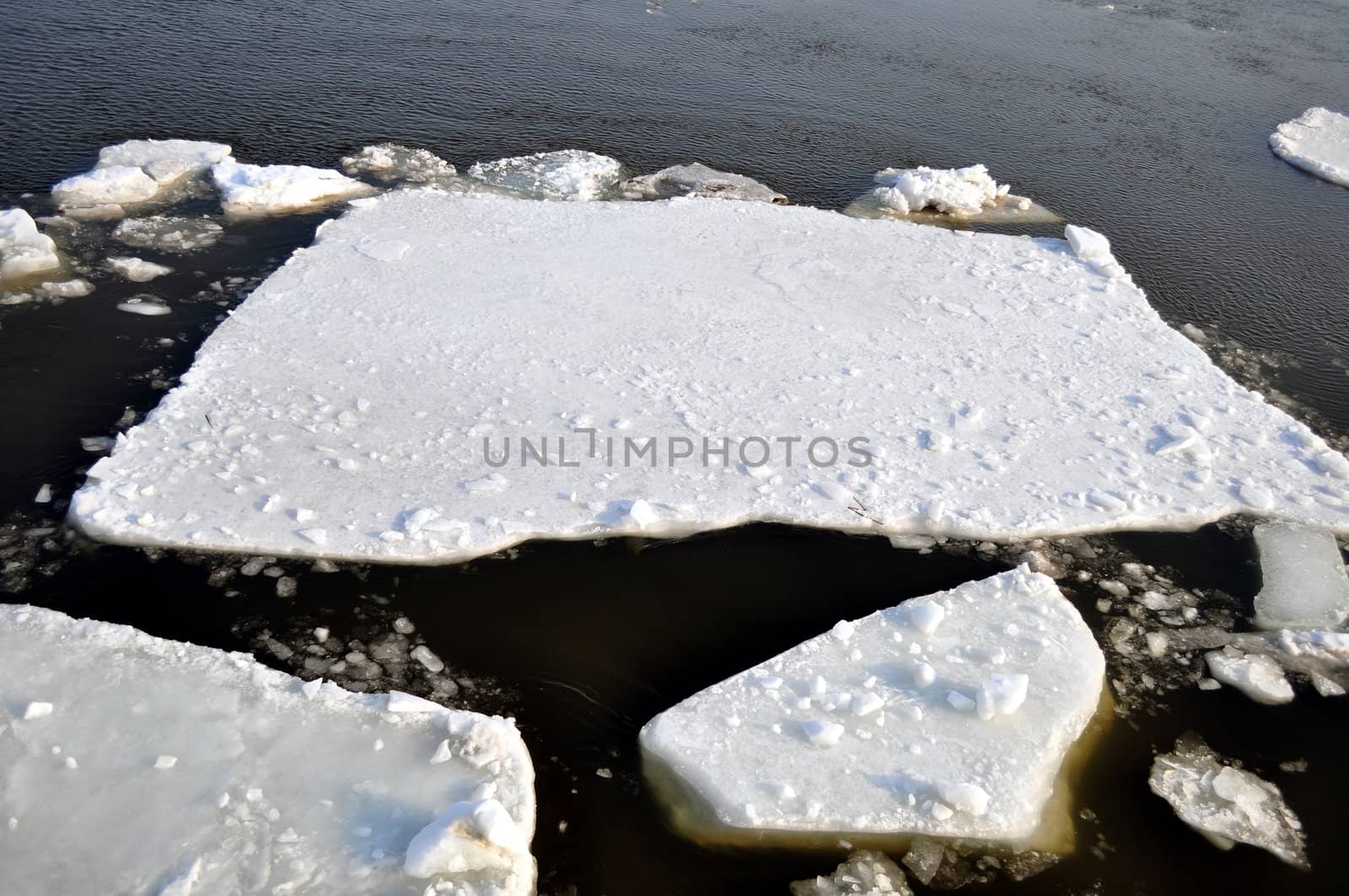 Winter scenery, ice blocks floating on river.