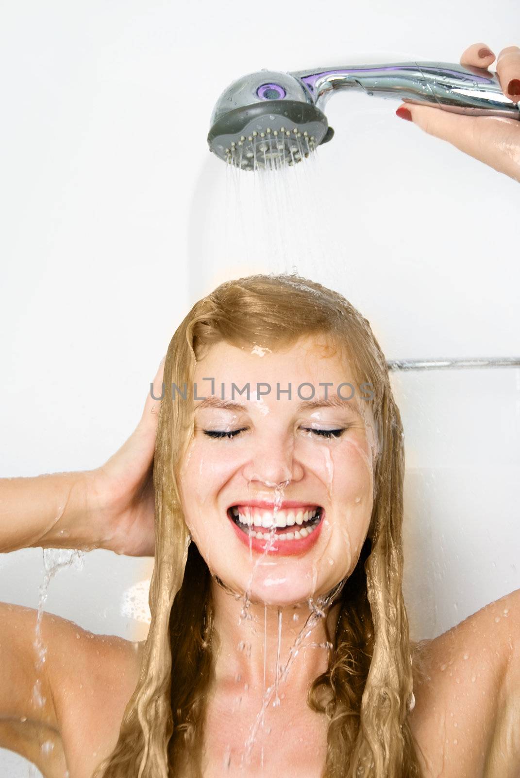 beautiful happy young woman taking a shower and washing her hair