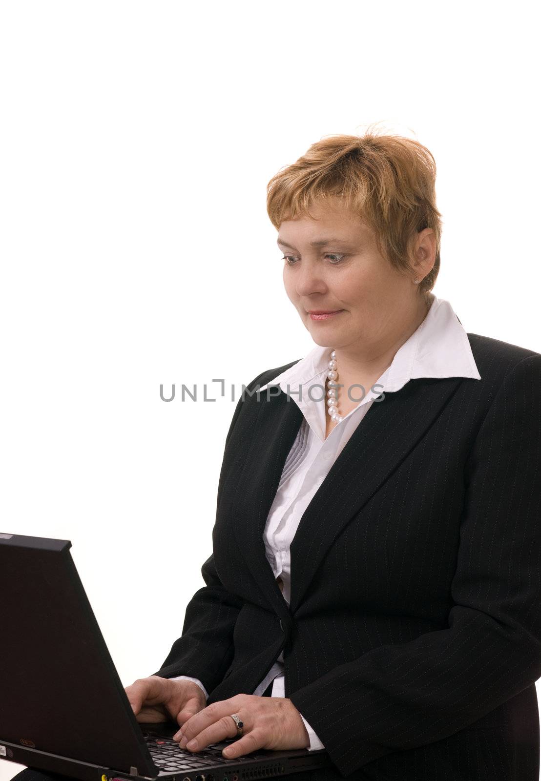 Mature businesswoman searching internet on her laptop computer