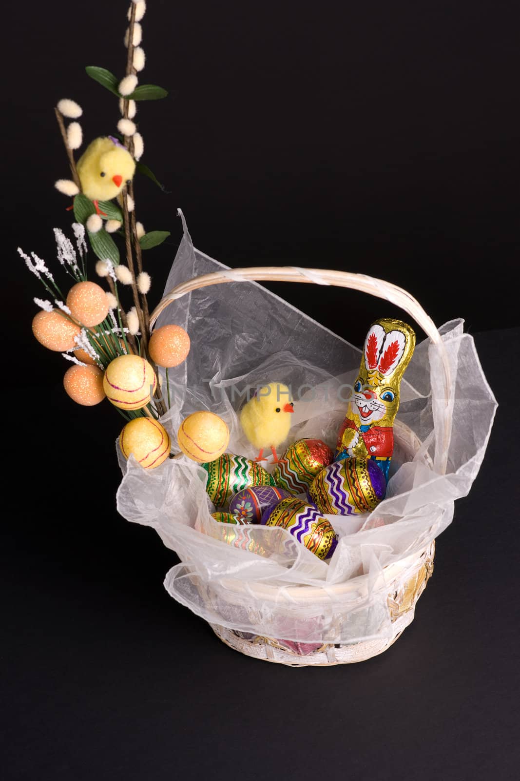 Easter holiday spirit basket with bunny chickens and colored eggs
