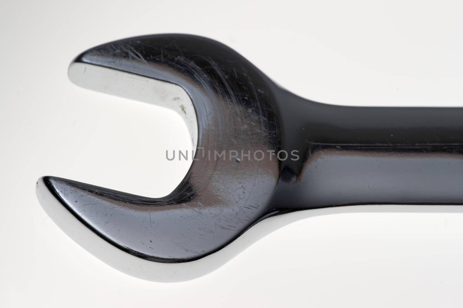 Extreme close up of a wrench head over white background