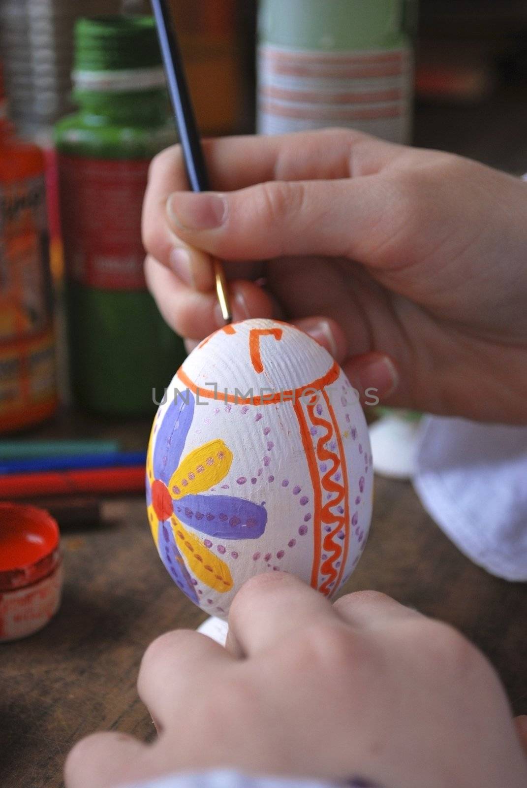 the girl enterring wooden egg, colour and paints