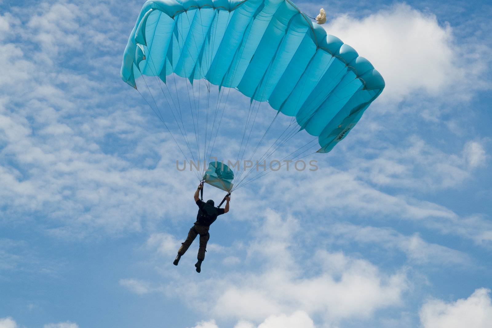Parachutist jump from airplane at sunny day