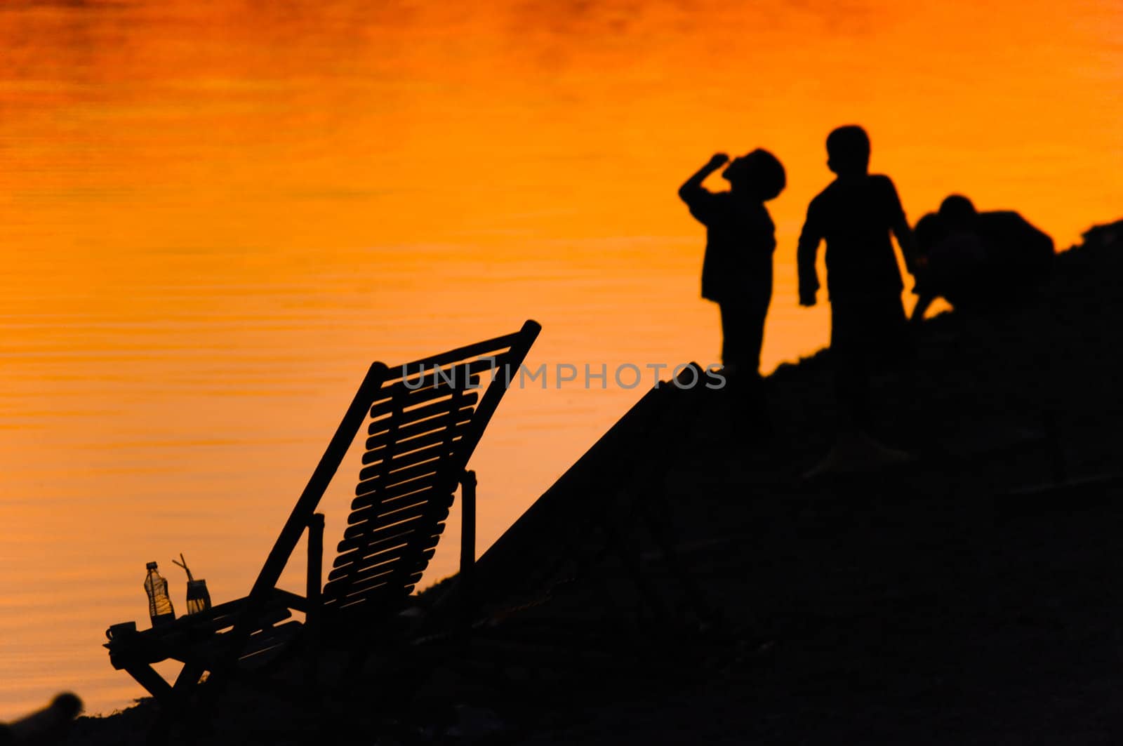 Vacation silhouette sunset scene of family on the beach