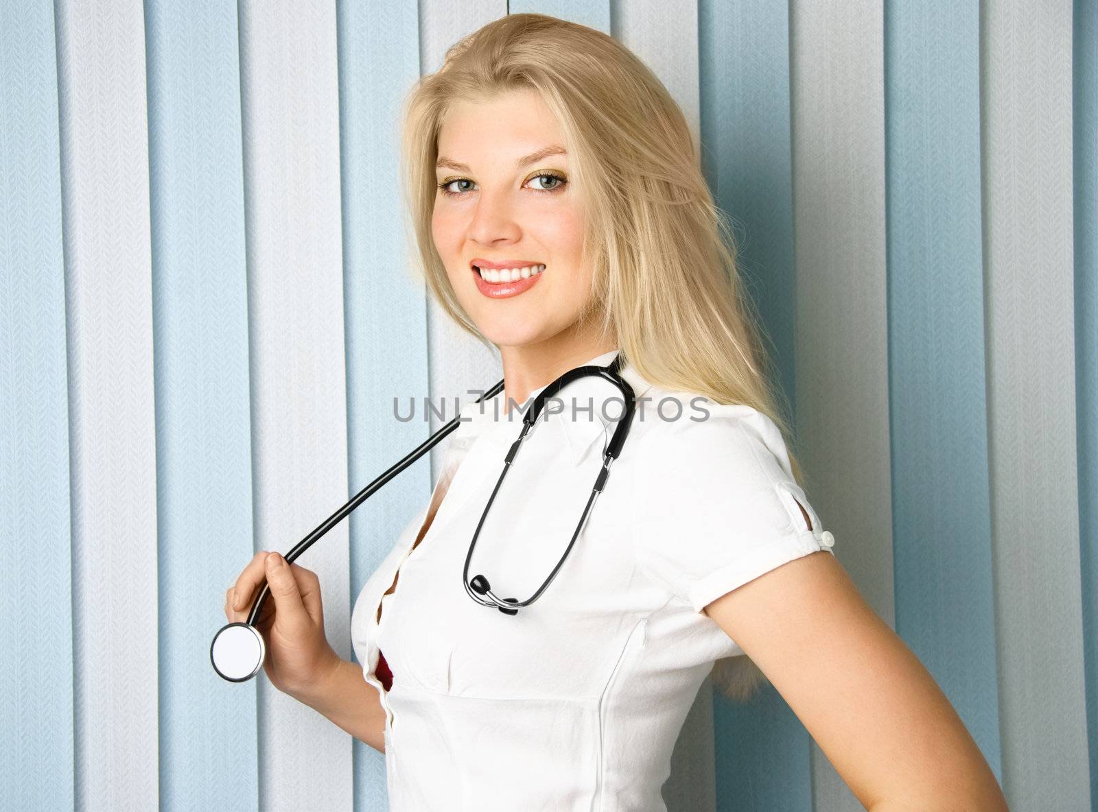 portrait of a young beautiful doctor with a stethoscope in the office