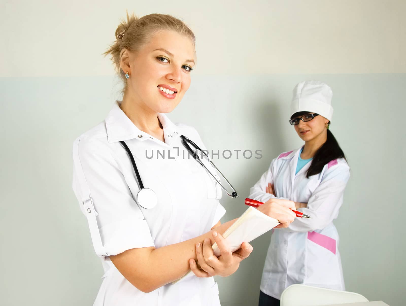 portrait of a young confident doctor with her assistant in the office