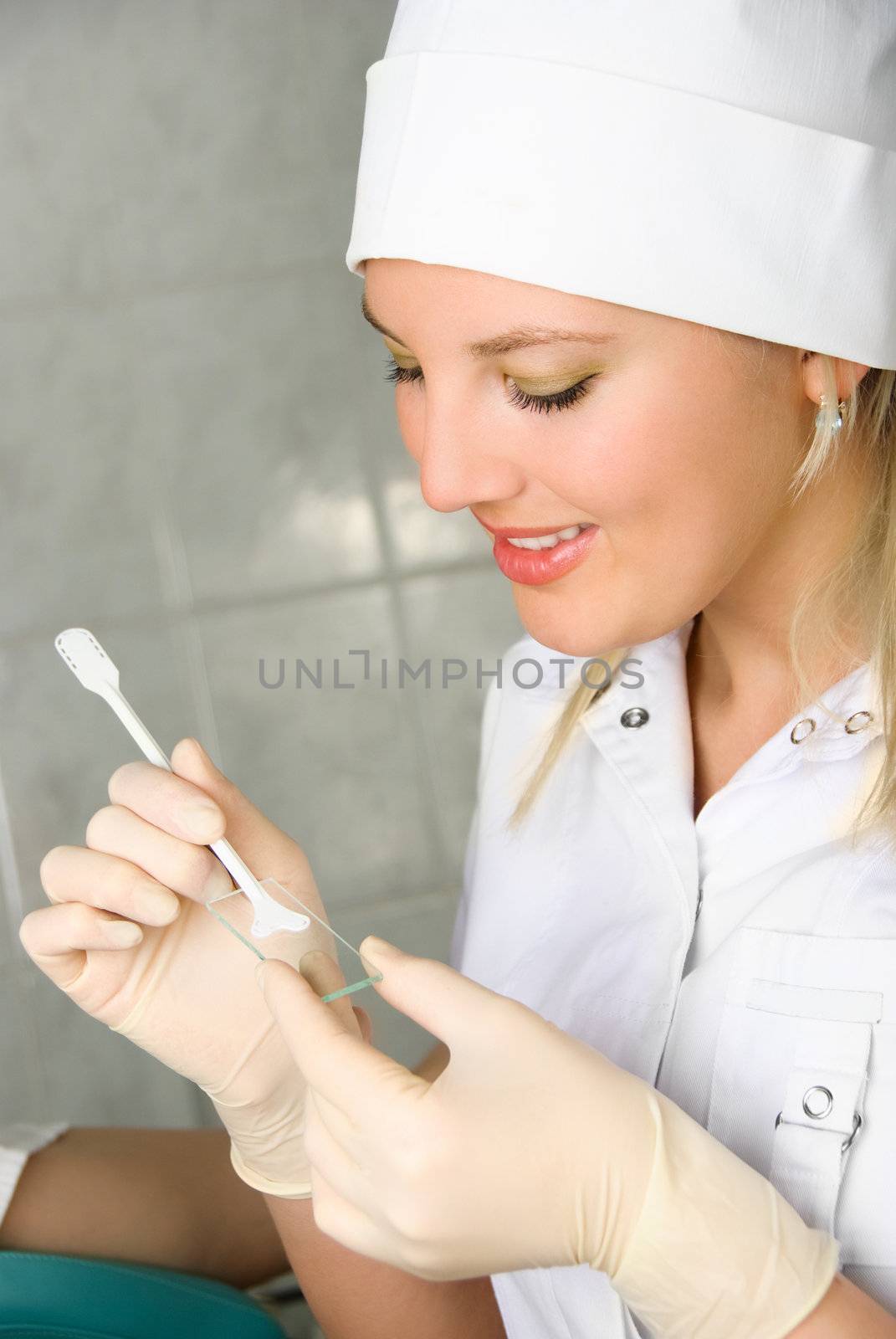 young gynecologist examining a patient in her office and taking analysis