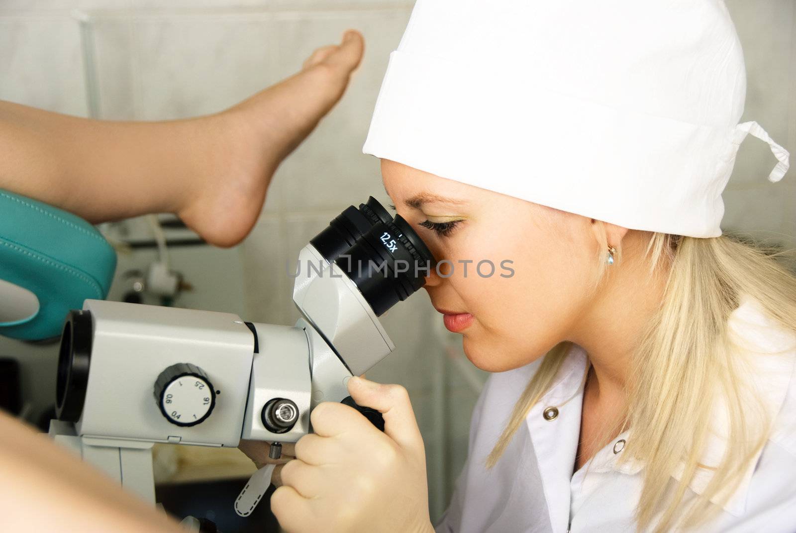 gynecologist examining a patient by lanak