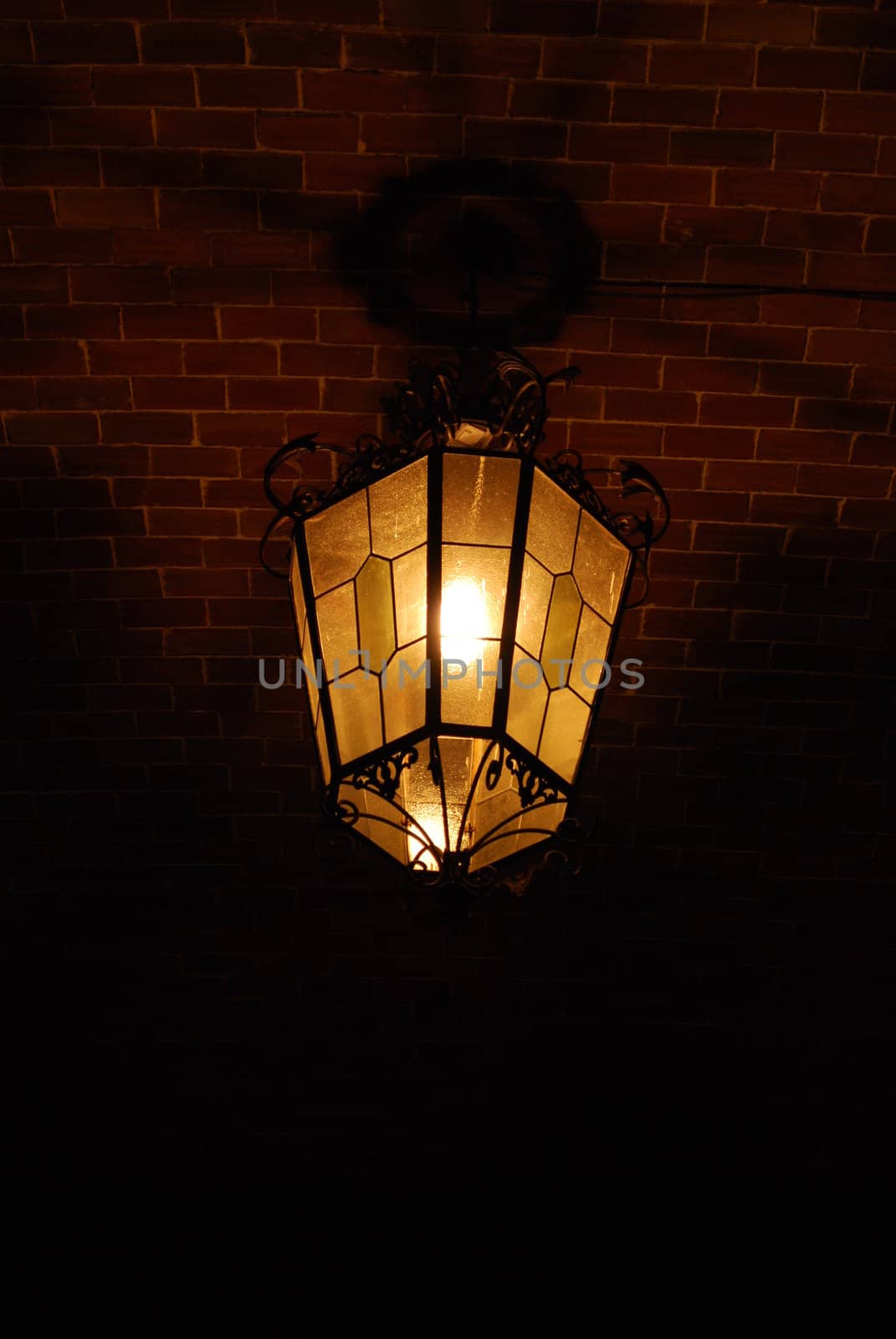 Ancient lantern on a brick wall by luissantos84