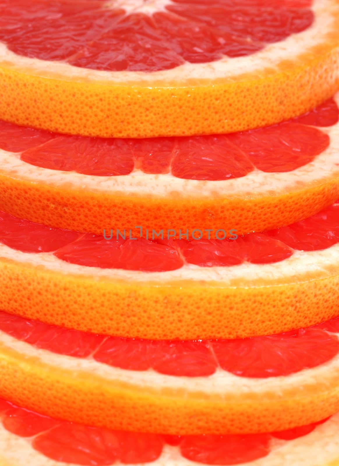 Cut grapefruit slice on white