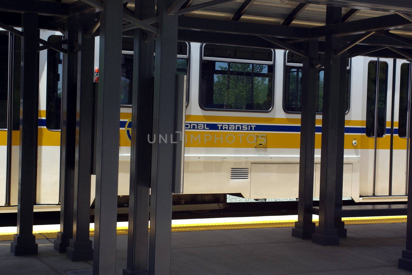 Local light rail train pulling up to the train station.