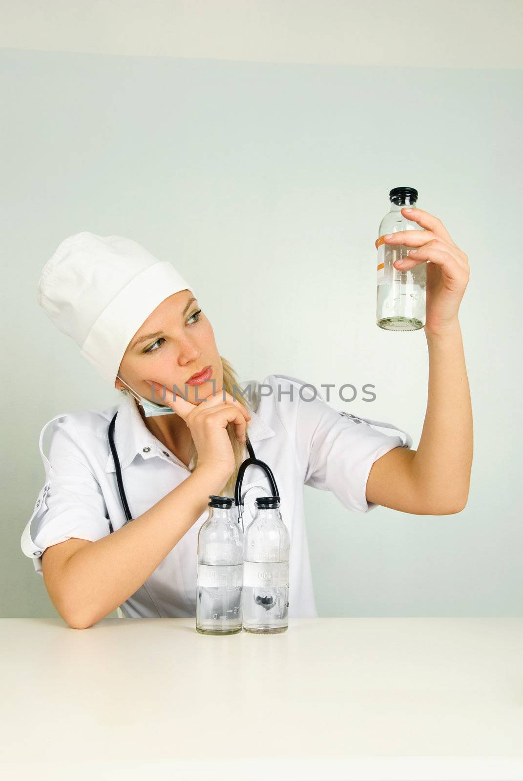 doctor with a stethoscope and medications  by lanak