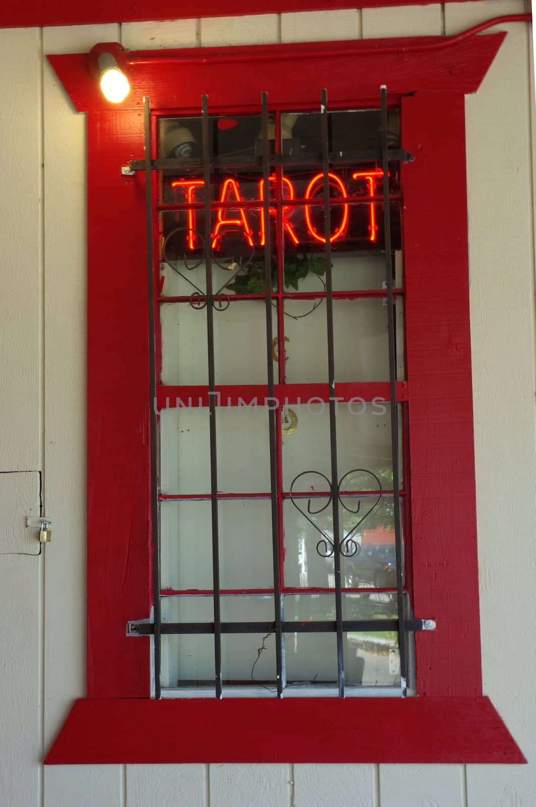 Tarot card reading sign advertising in a building window.