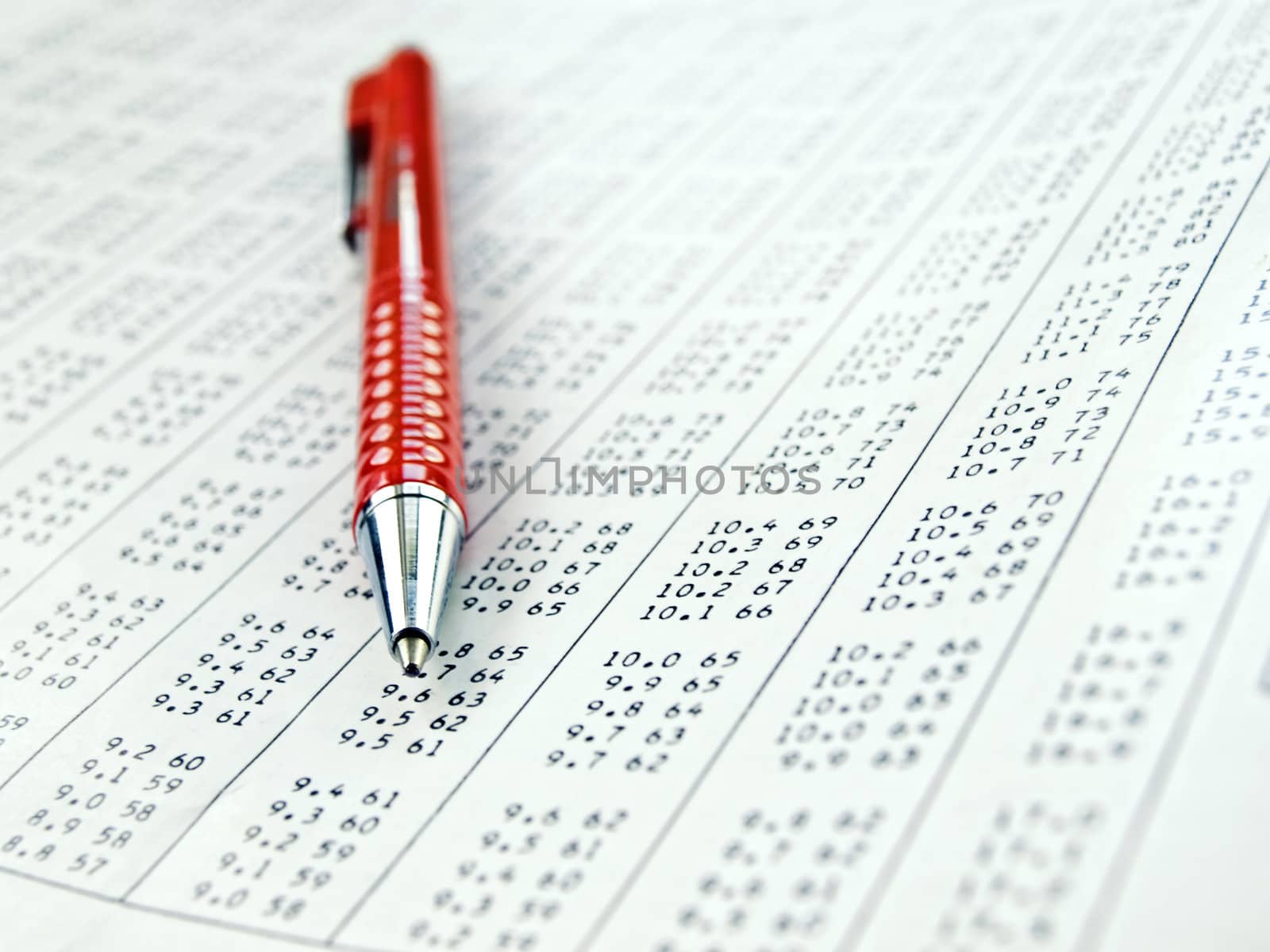 data table with red pen on it , close-up with shallow DOF