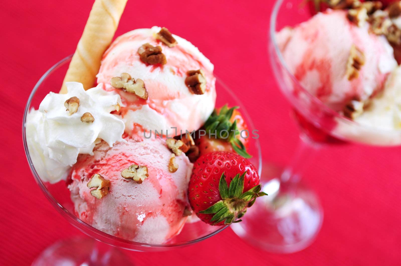 Strawberry ice cream sundae with fresh strawberries and walnuts