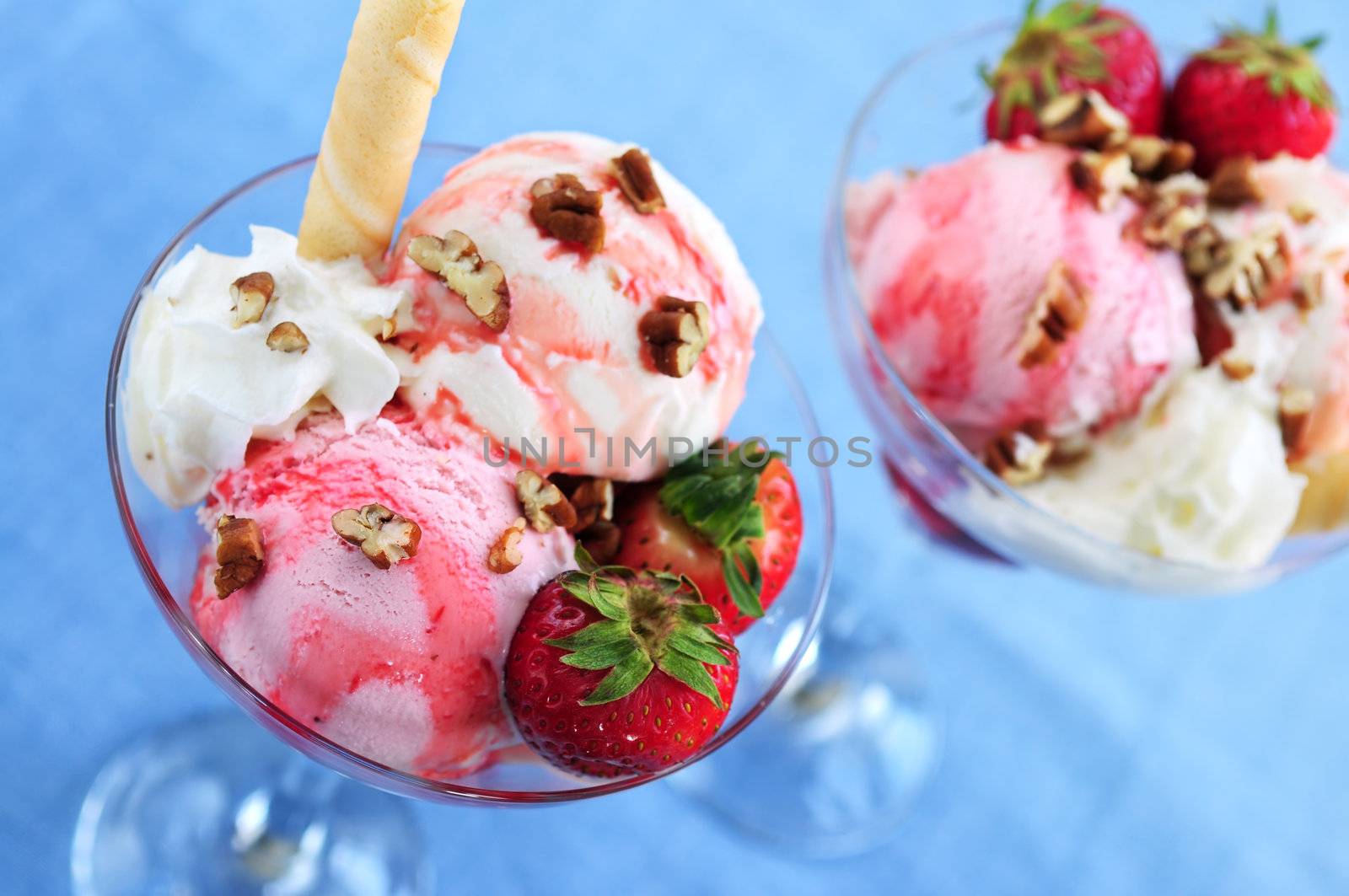 Strawberry ice cream sundae with fresh strawberries and walnuts