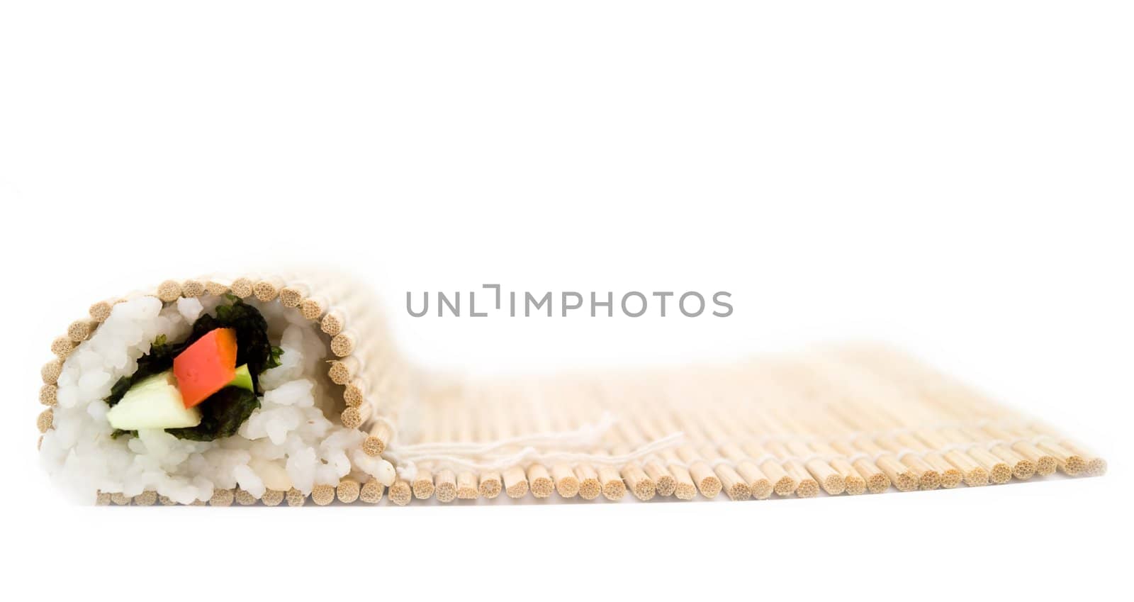 Cooking sushi. Bamboo rug on a white background