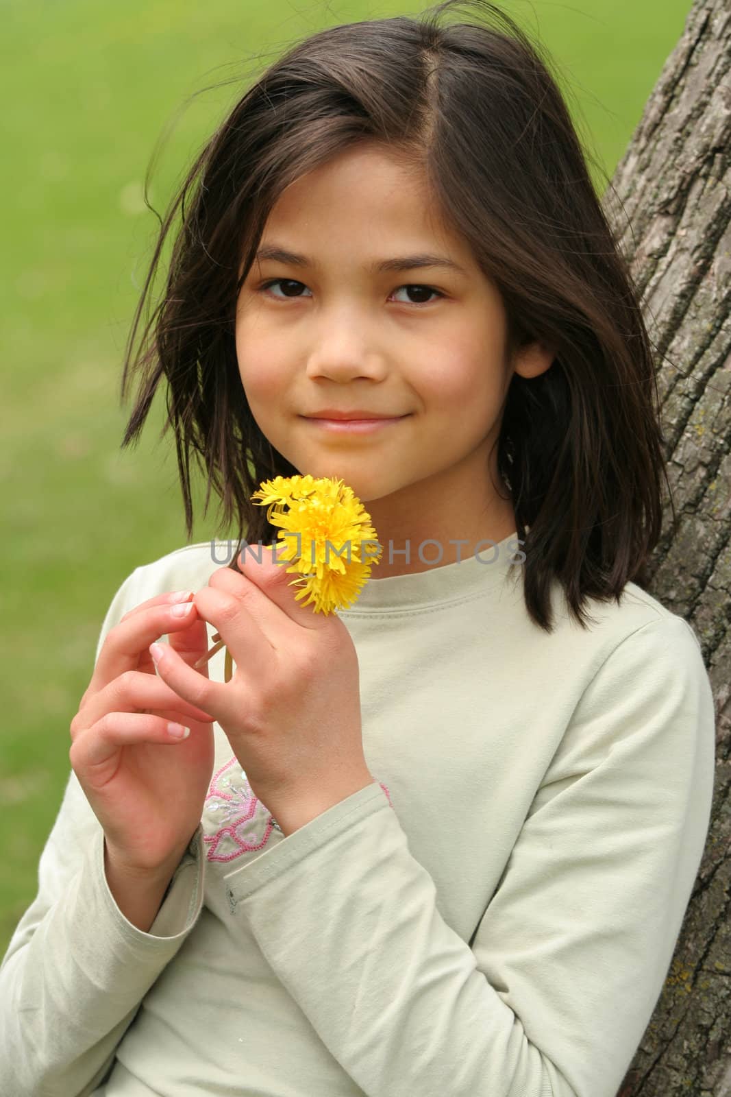 Girl holding freshly picked dandelions