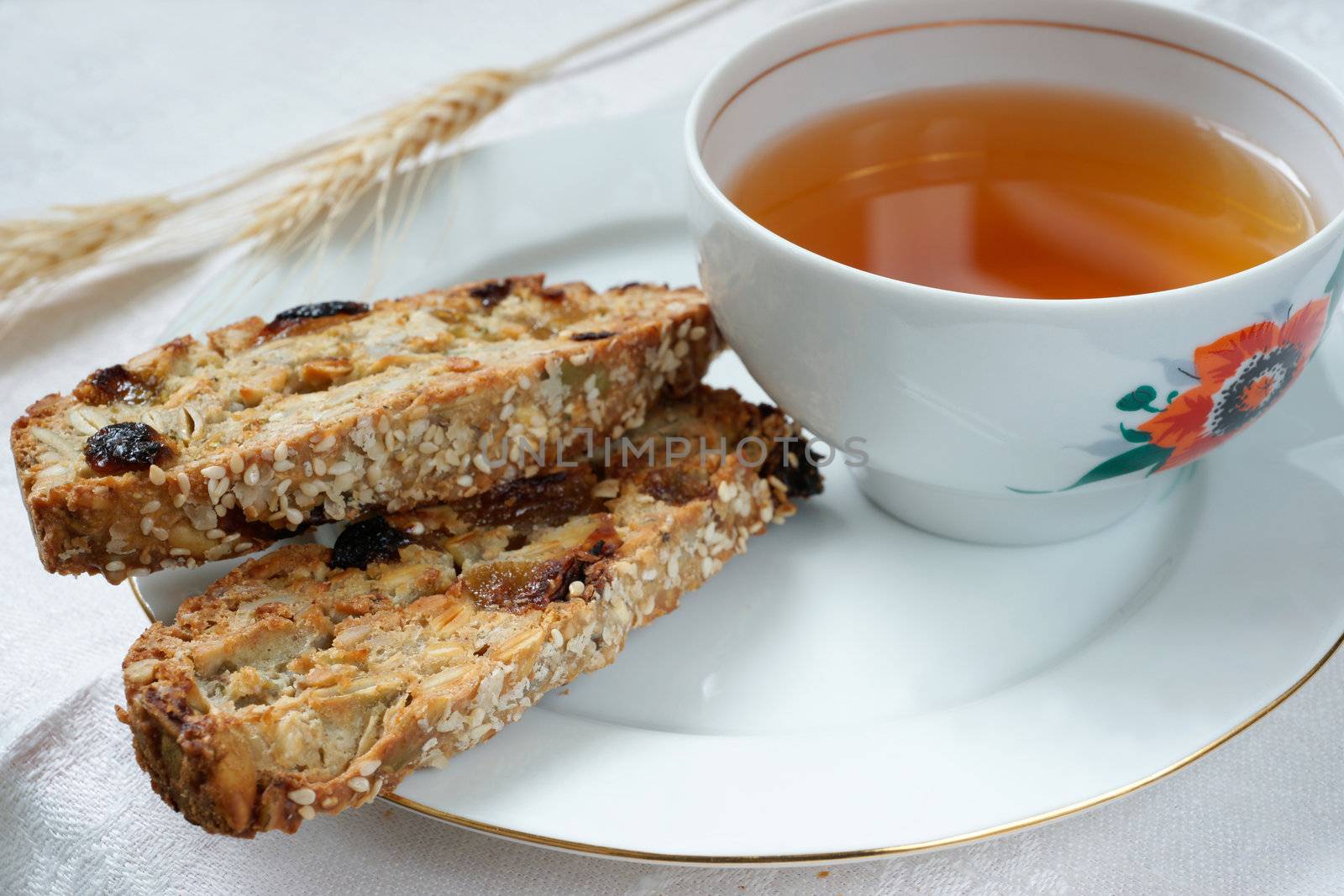 Cup of tea with biscotti cookies on the plate