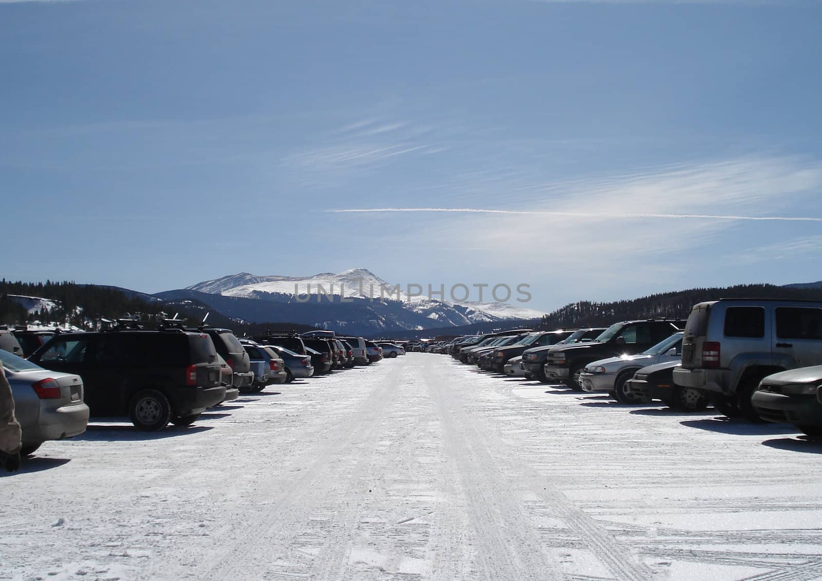 The parking lot for a Colorado ski resort extends out into the horizon.  