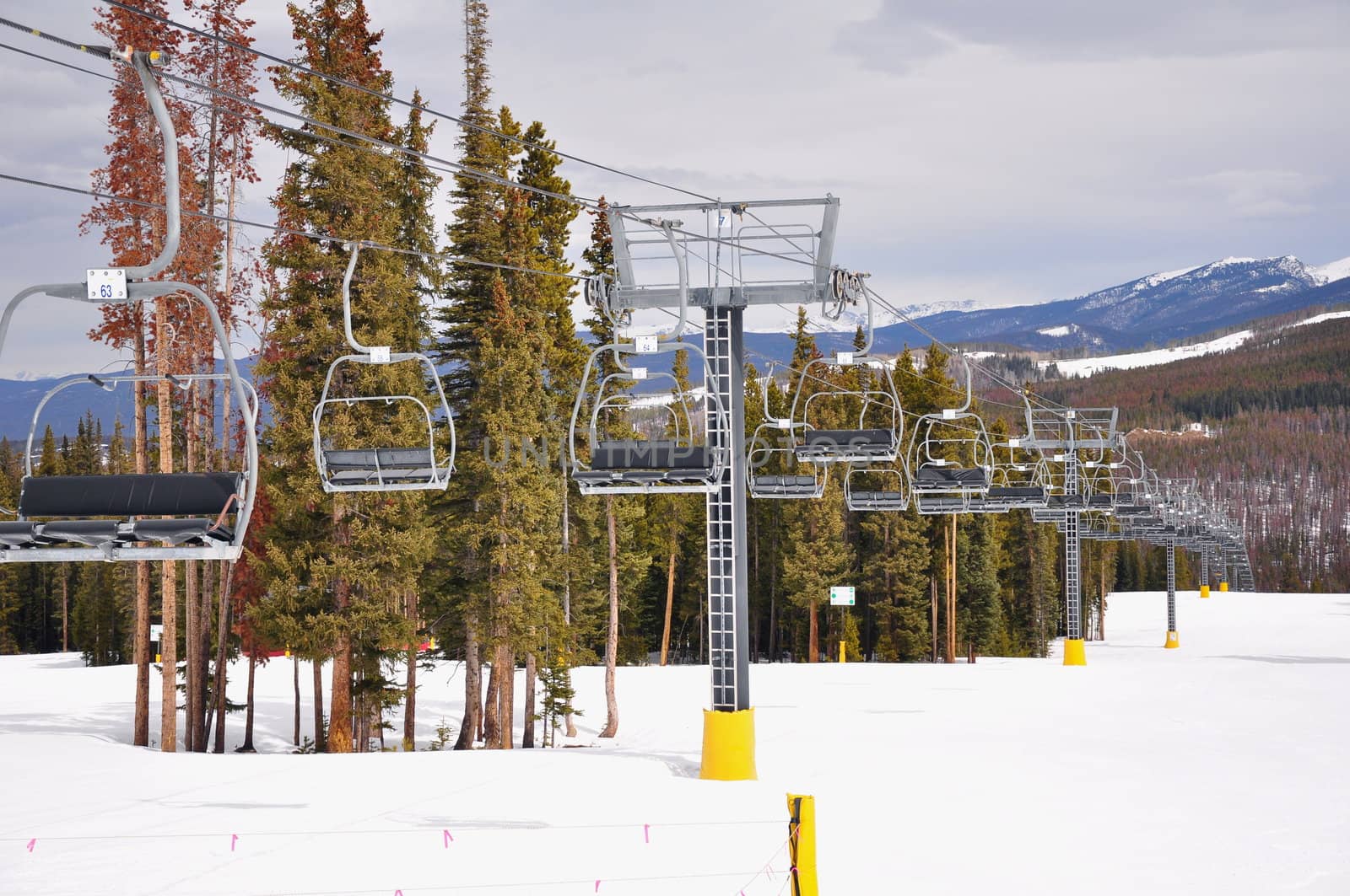 Chair lift seats are empty and still at a Colorado ski resort.