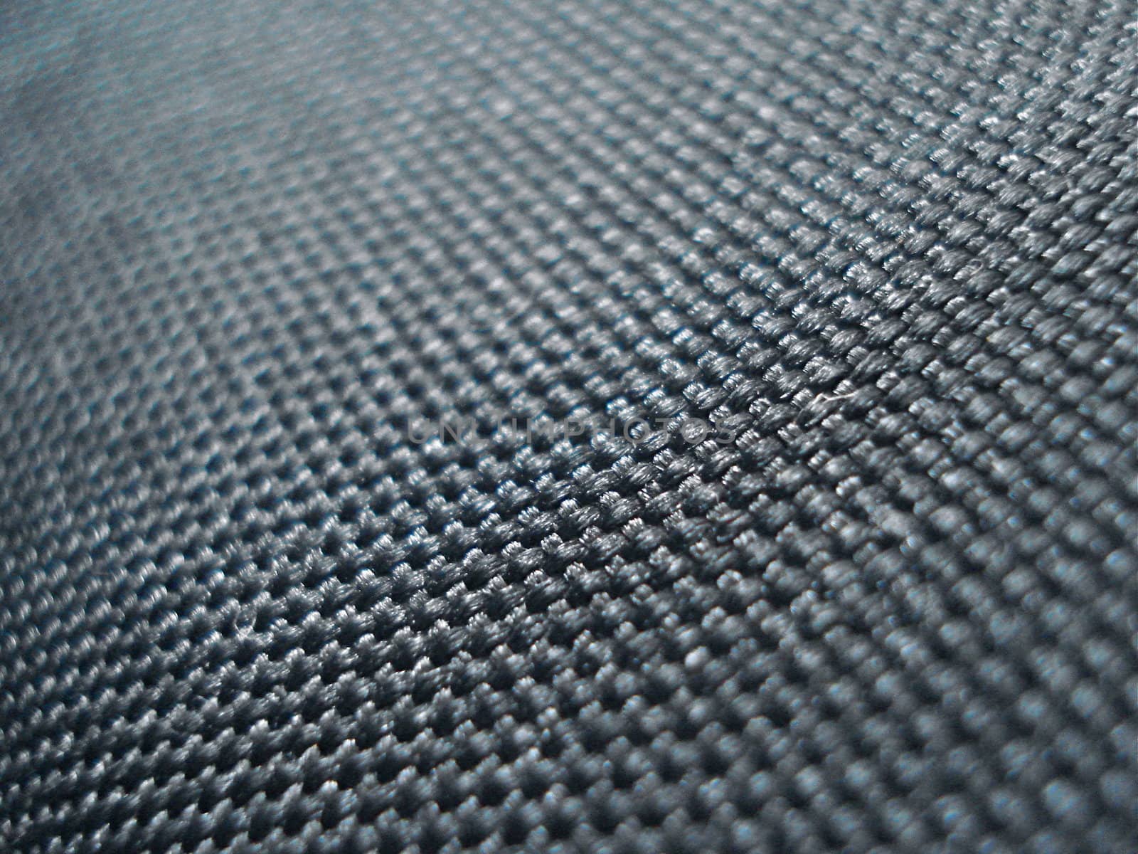 A shallow depth of field shot of black, textured fabric.