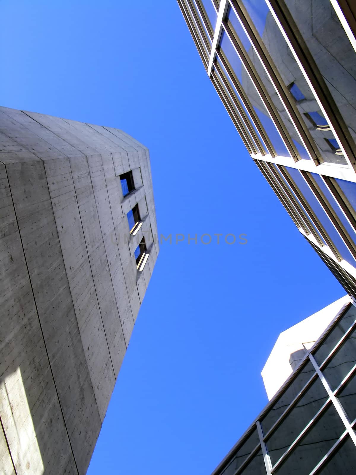 3 buildings shot in perspective on a clear blue sky.
