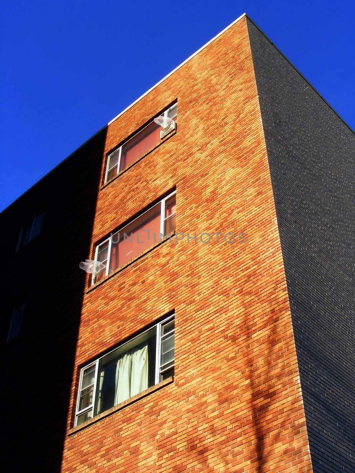 Abstract shape, light and shadow define the form of this old apartment building.