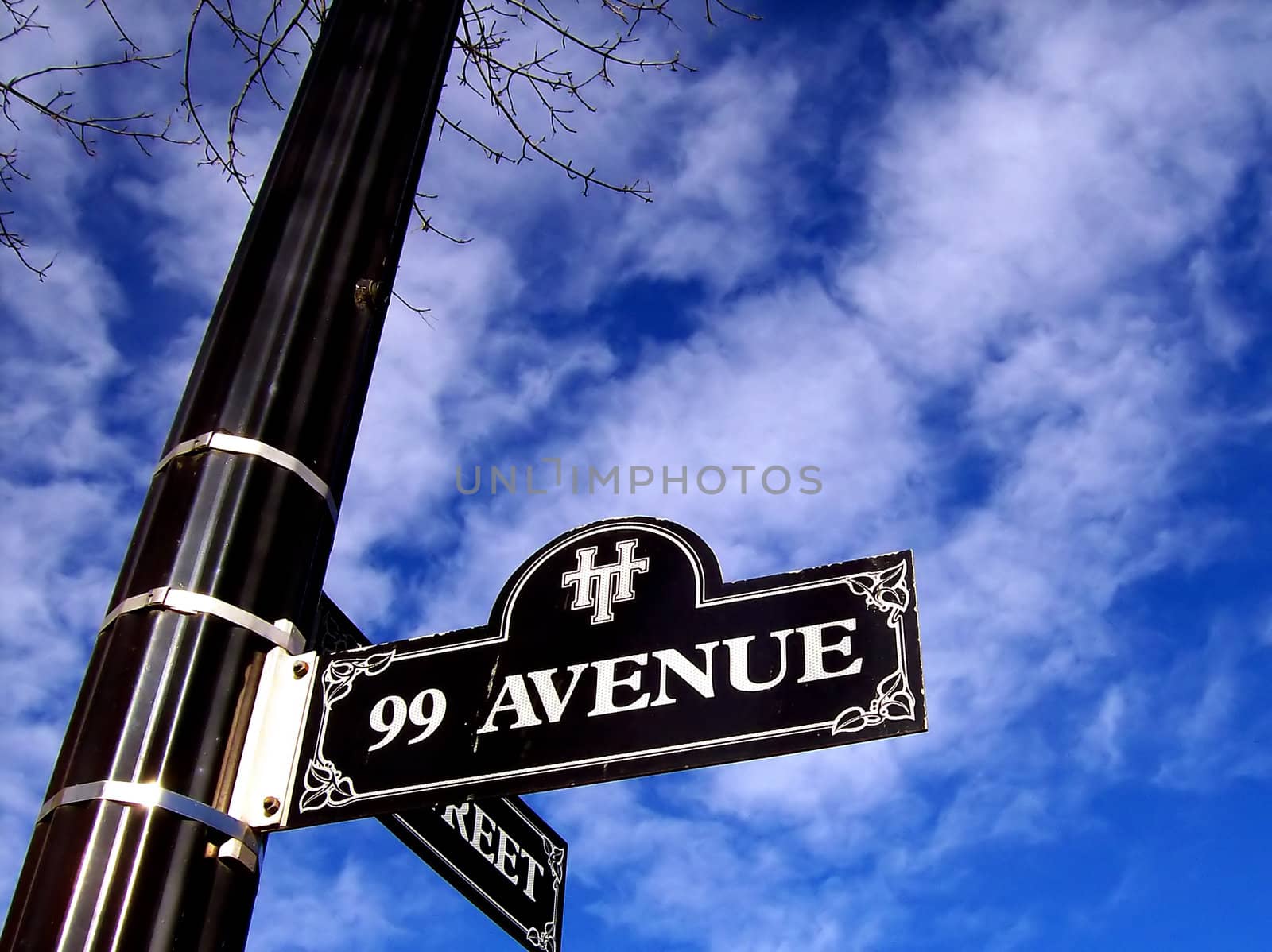Stylish street sign and post on blue sky.