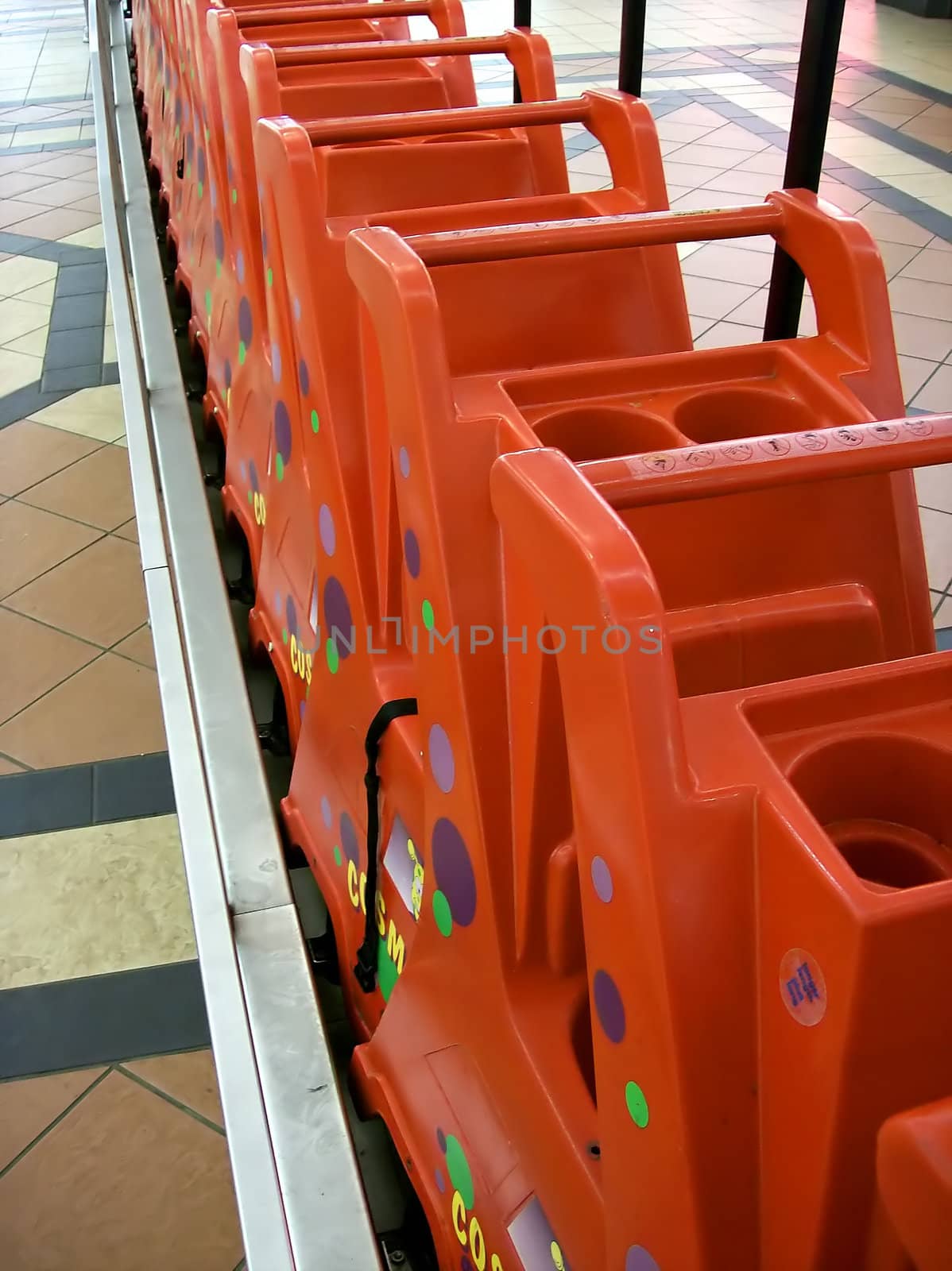 Child carts waiting for hire in a shopping mall.