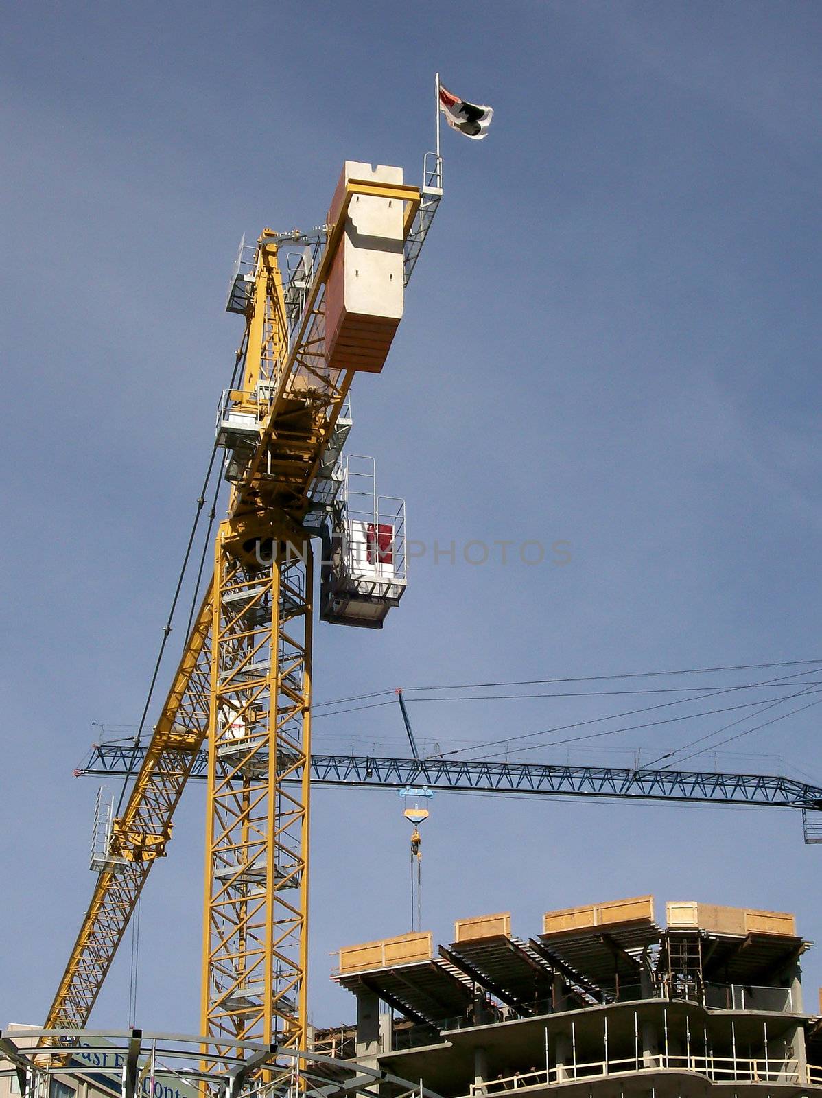 Cranes criss cross carrying loads to the highest levels.