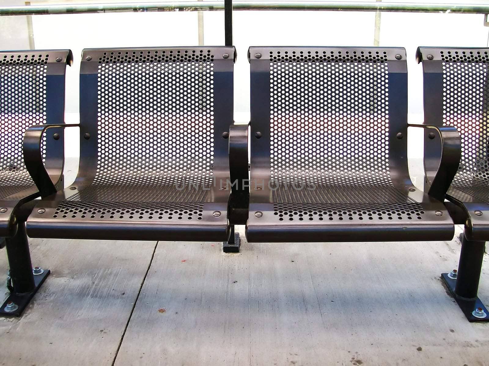 Iron seating at a train stop.