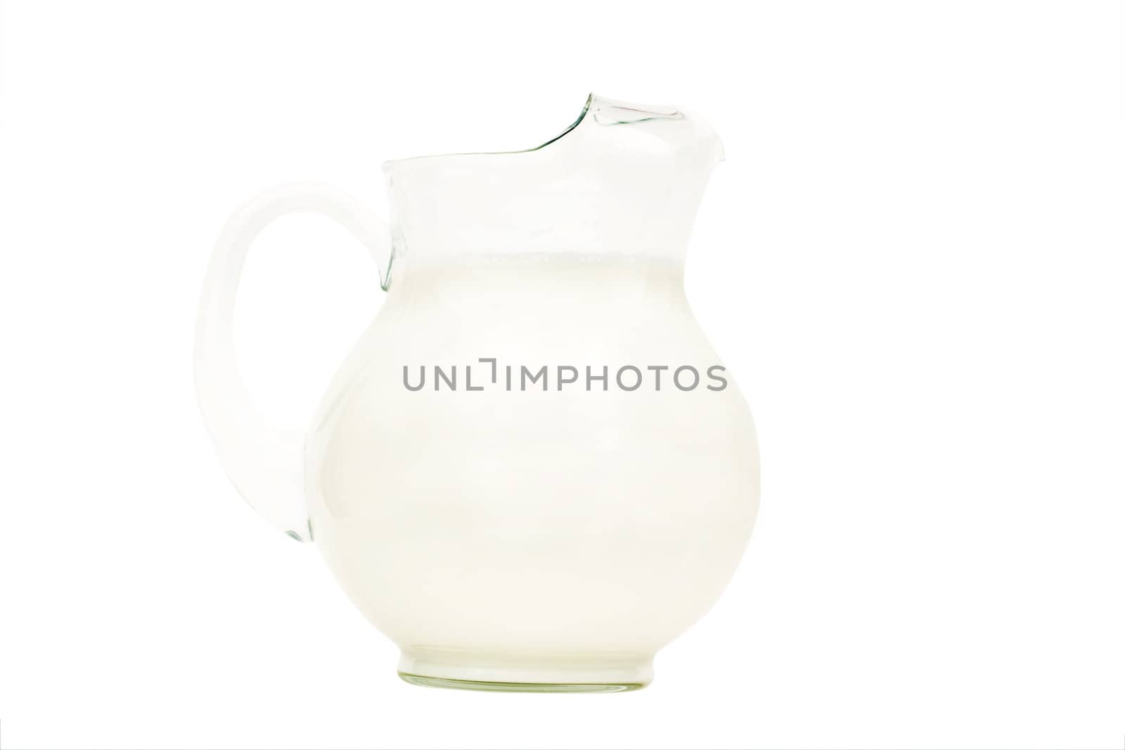 Glass pitcher of milk isolated on white