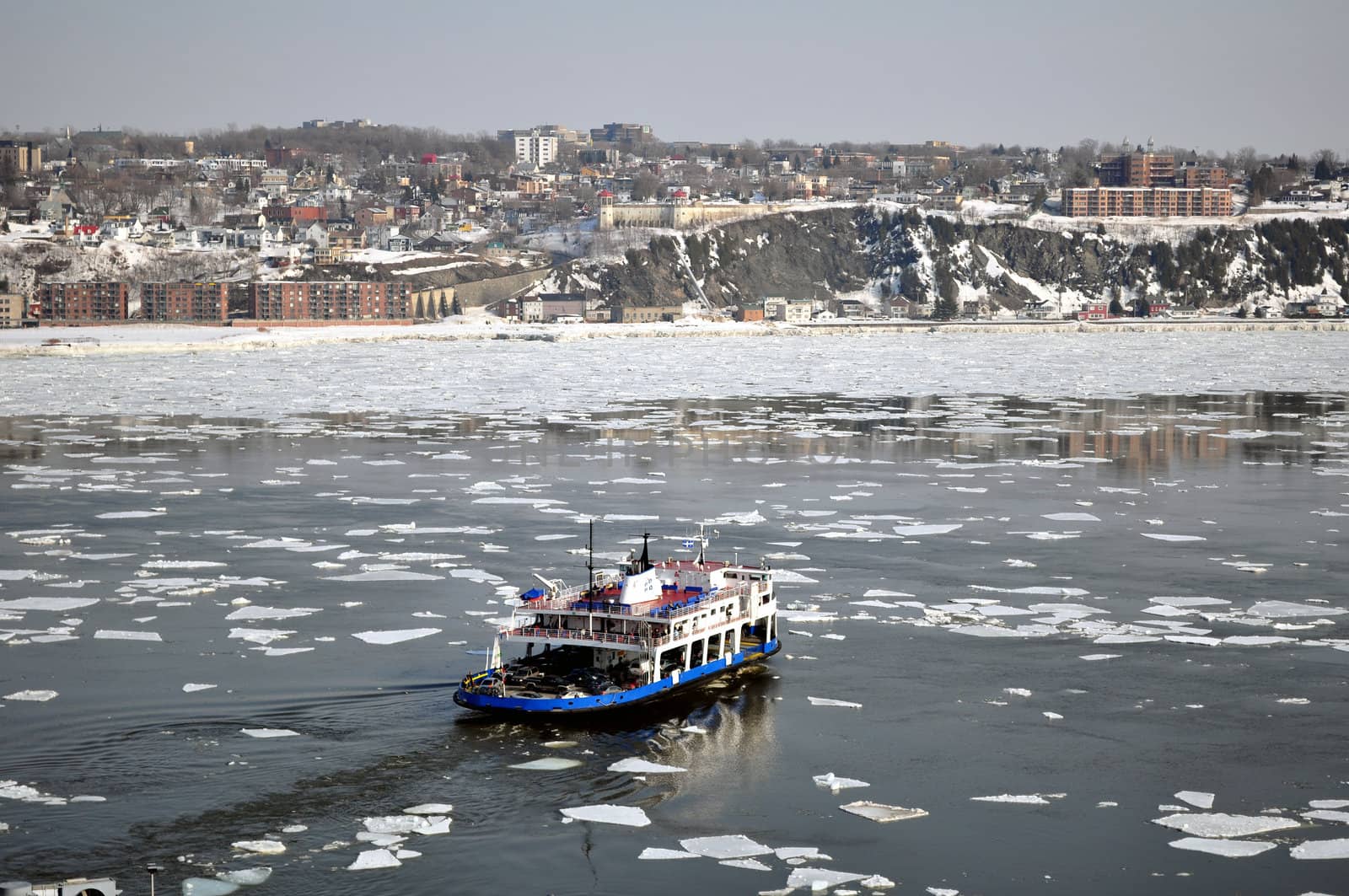 Transportation: Ferry boat crossing river in winter