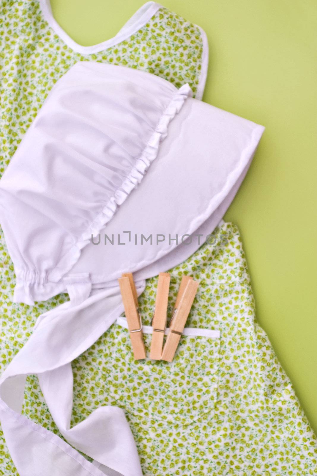 Amish child's clothes with bonnet and clothes pins.
