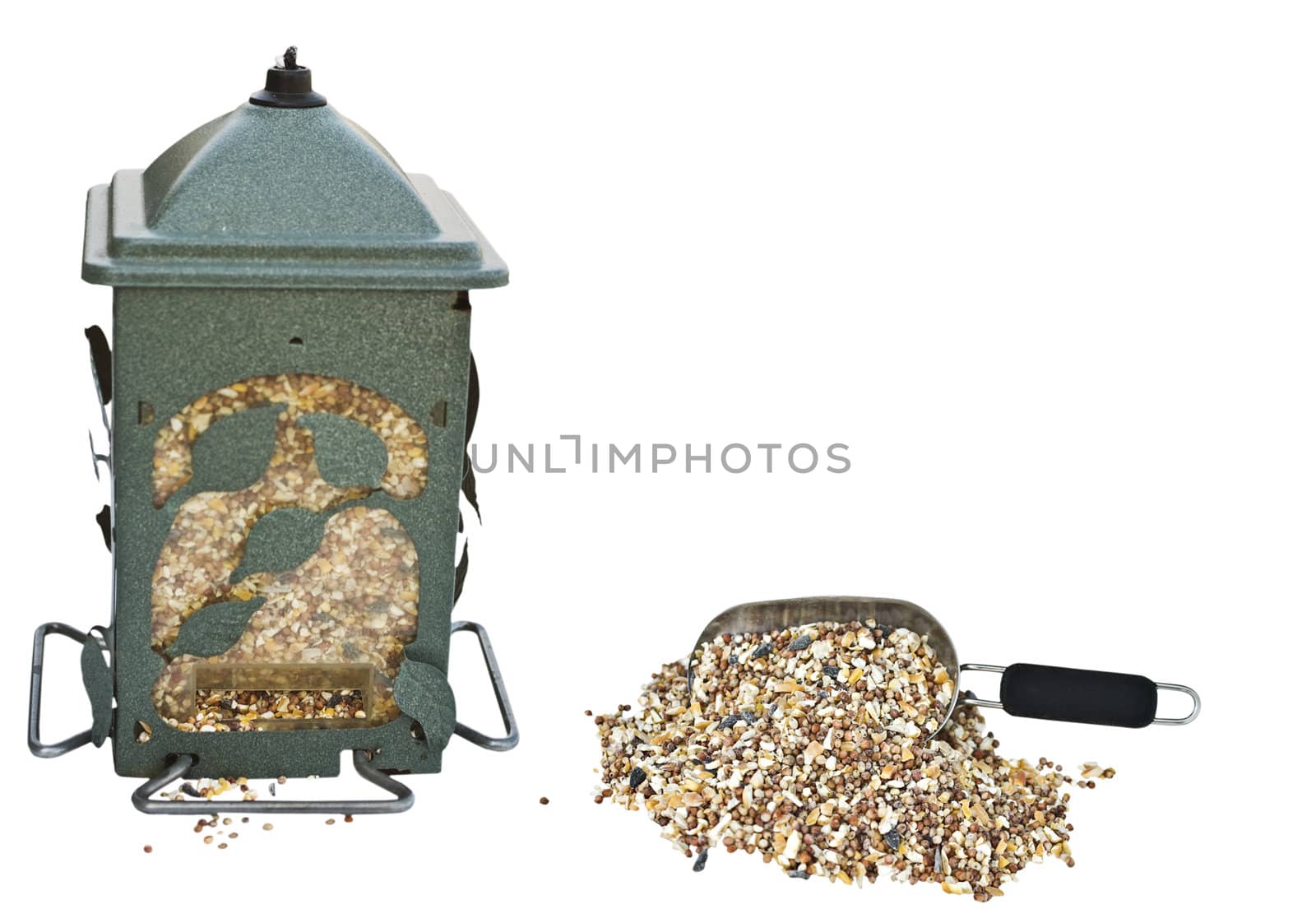 bird feeder filled with seeds with a scoop of seeds by StephanieFrey