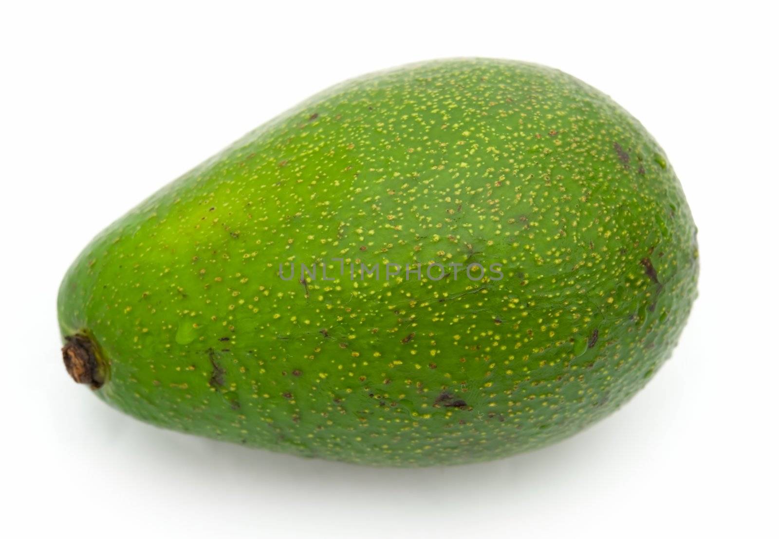 green avocado on a white background