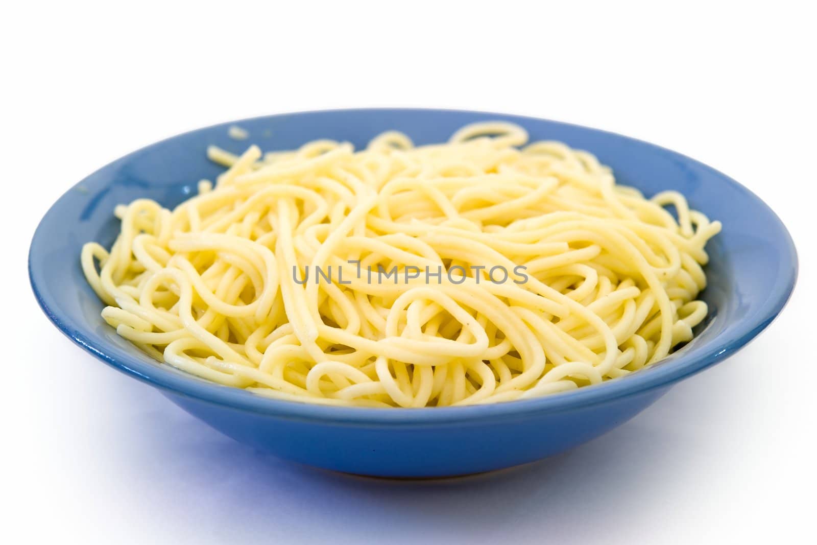 Spaghetti in a blue plate on a white background