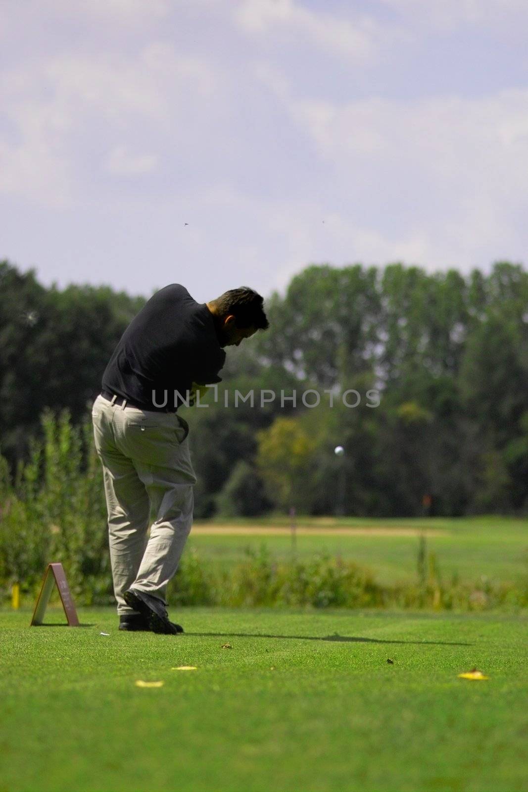 golfer is hitting the golfball by peromarketing