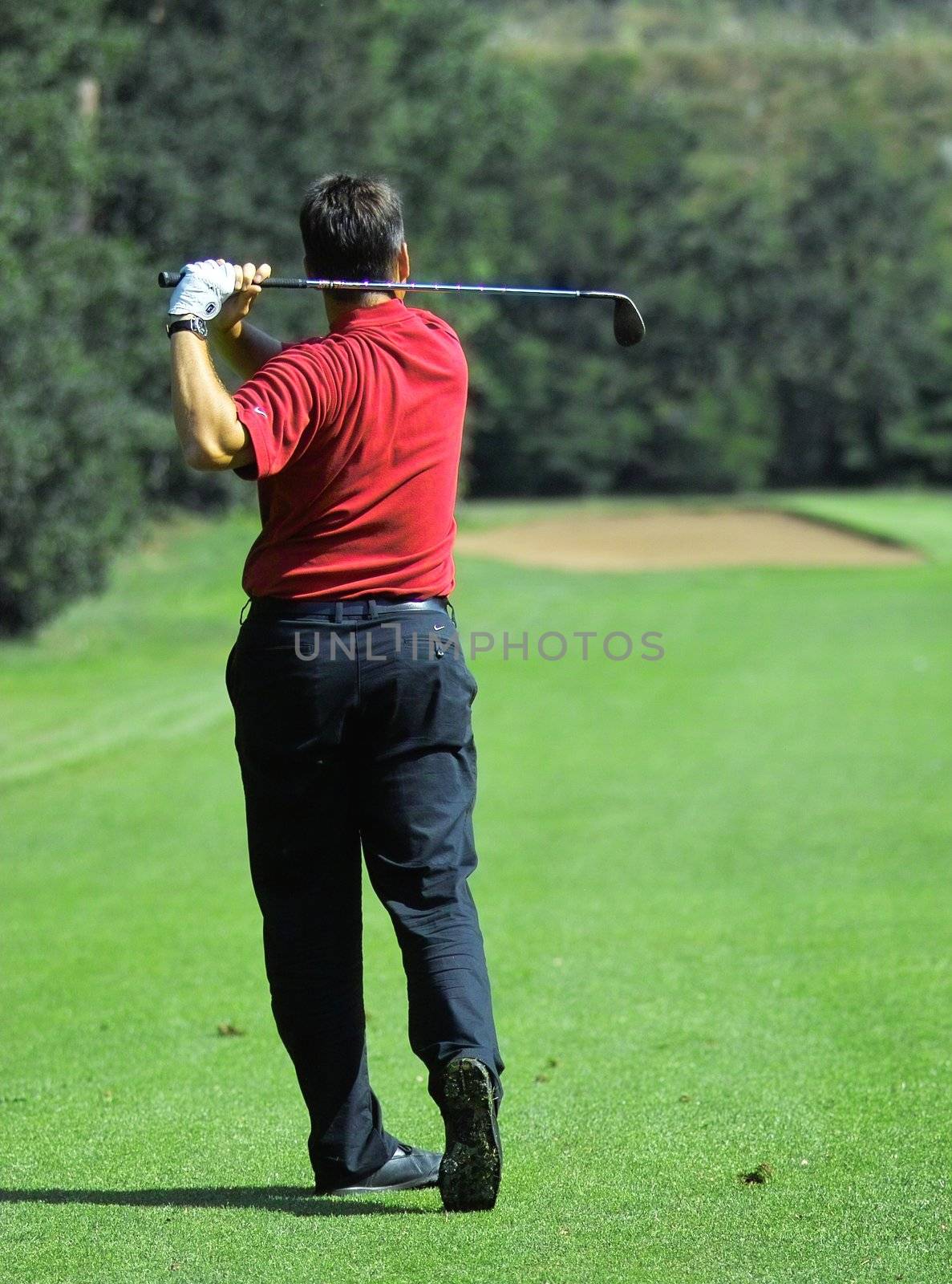 golfer on a golf course by peromarketing