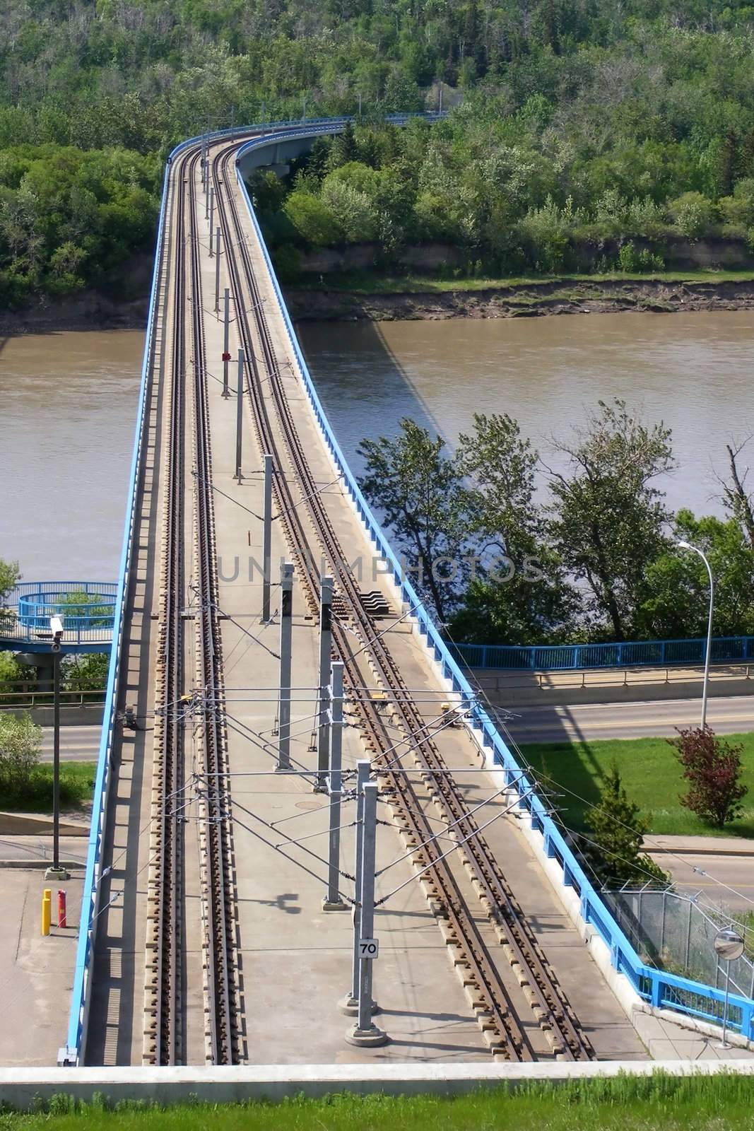 Light rail transit tracks and bridge over river.