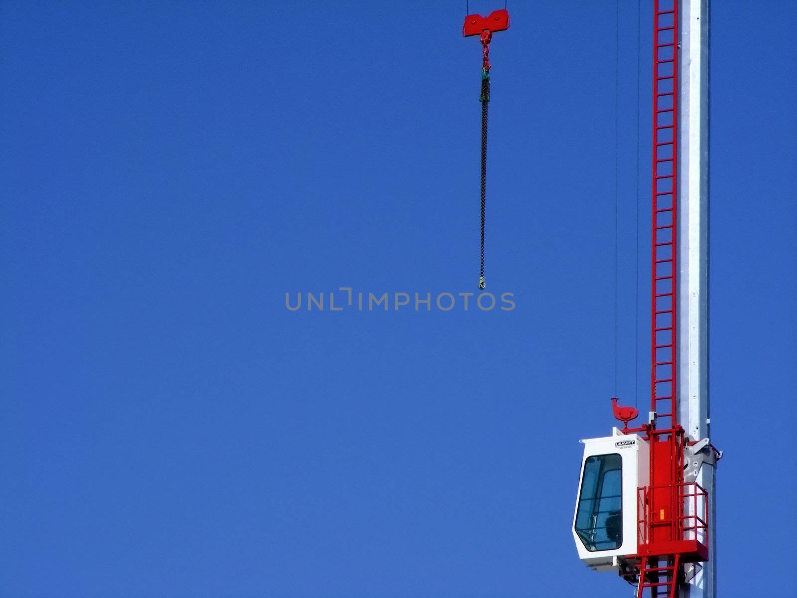 Red and white crane isolated on a blue sky