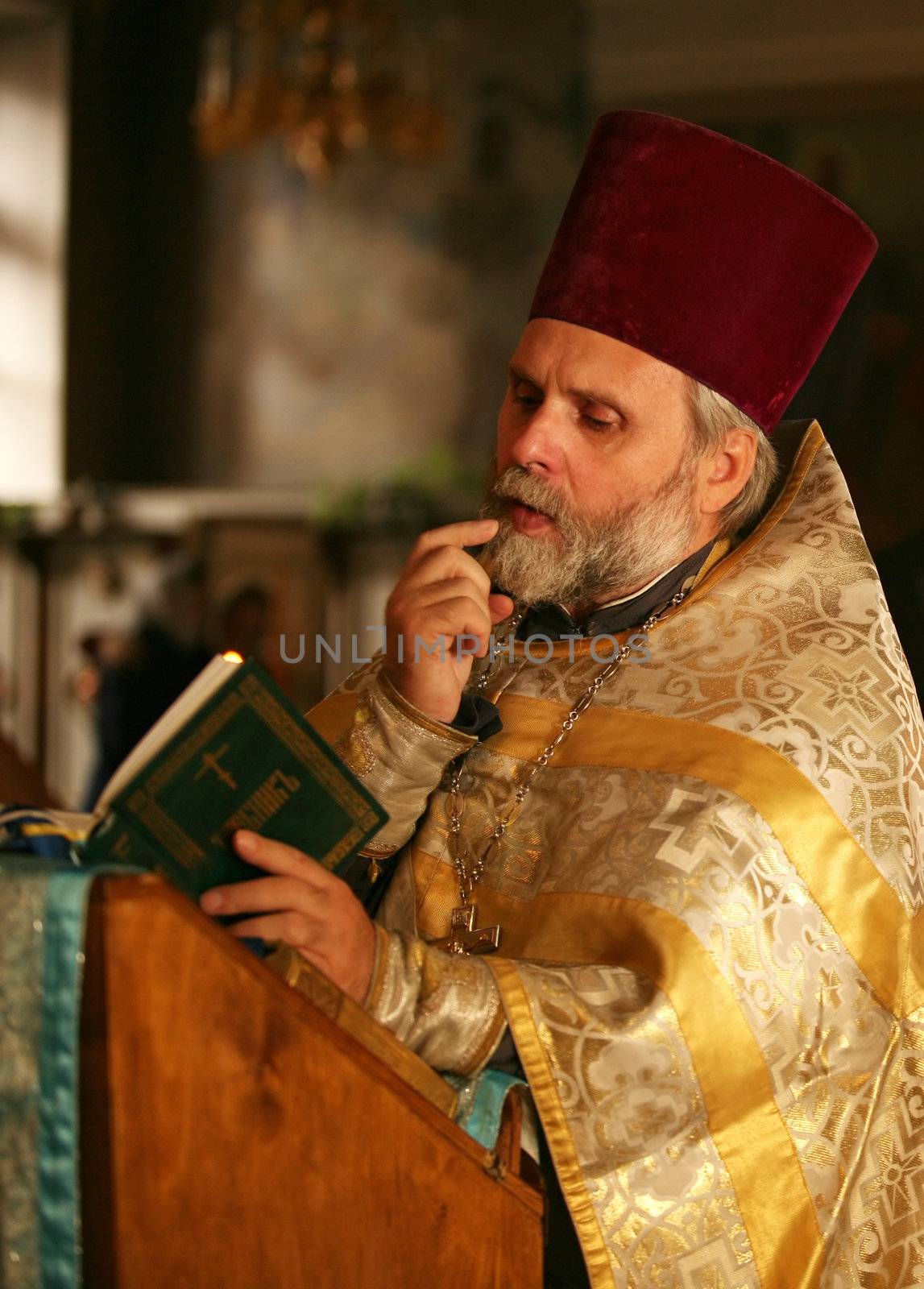 The priest with the Bible on ceremony of wedding of a newly-married couple. Moscow, the Patriarchal farmstead