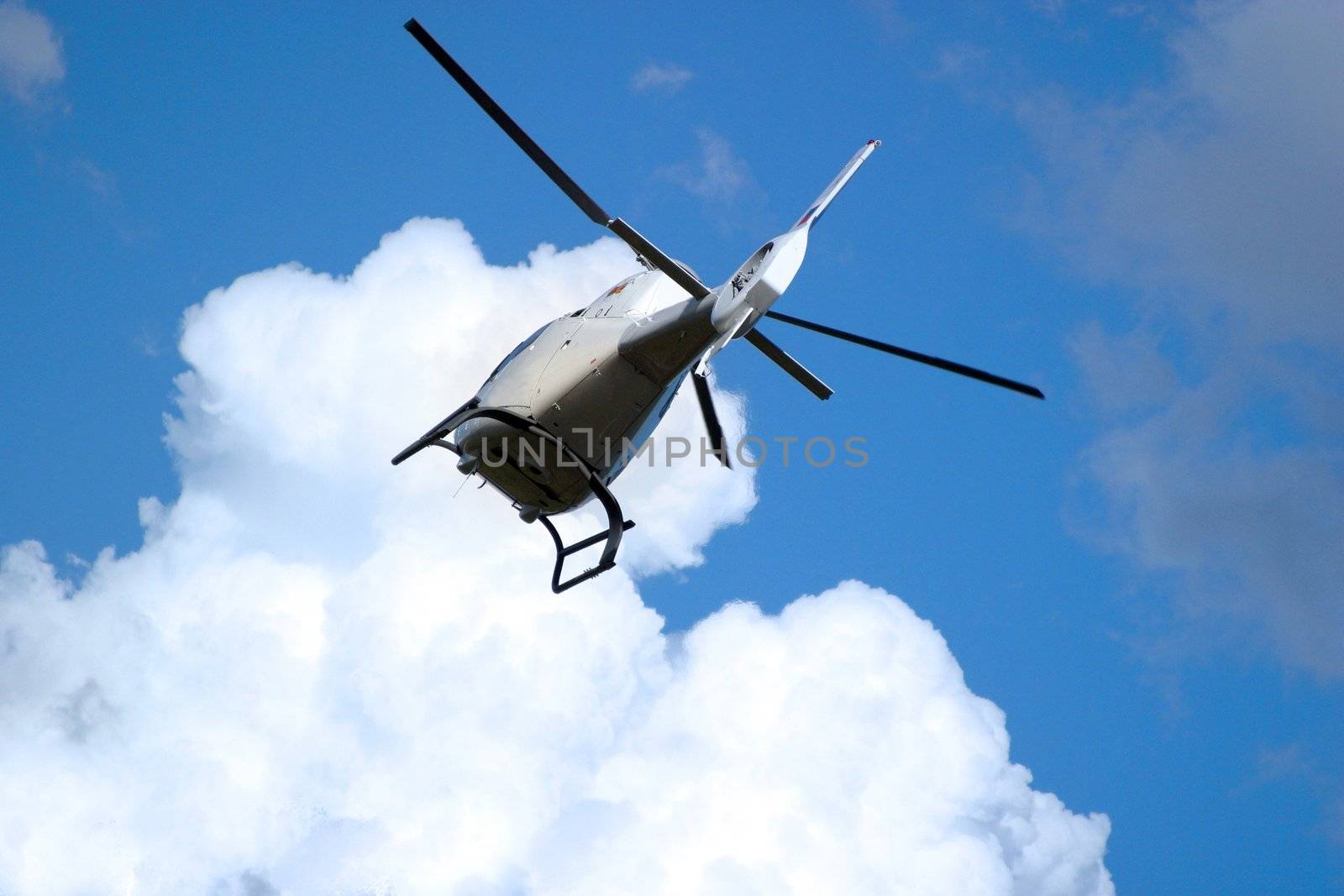 The helicopter in the sky with clouds