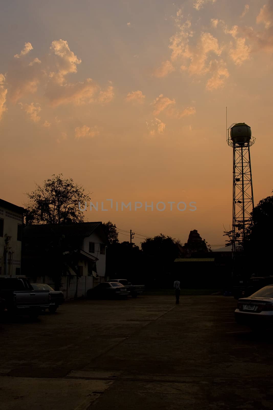 Sunset in Chiang Mai, Thailand with water tower silhouette. Nice city scene.