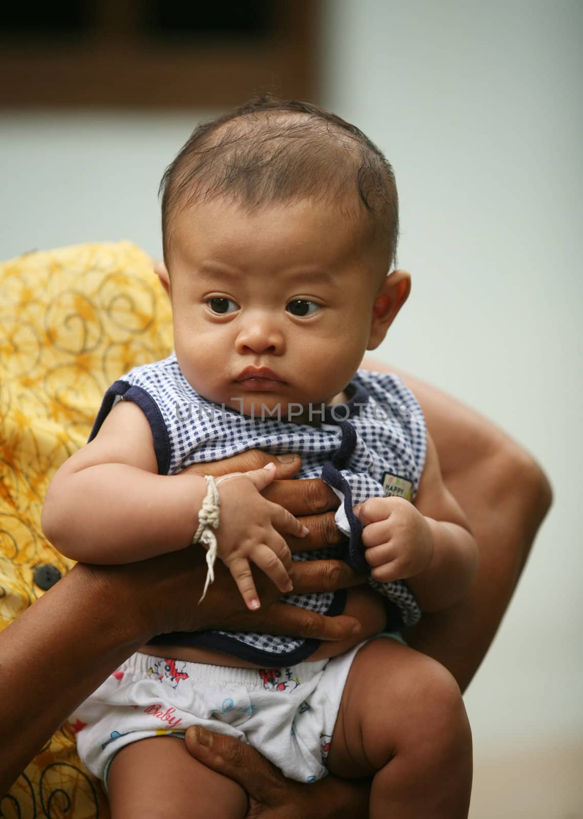 The small Indonesian boy on hands at the adult person