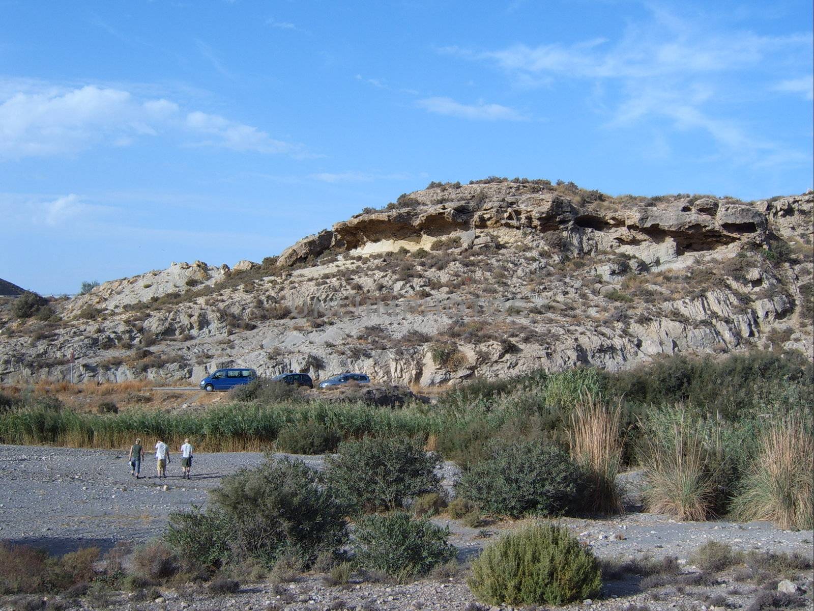 people walking towards mountain