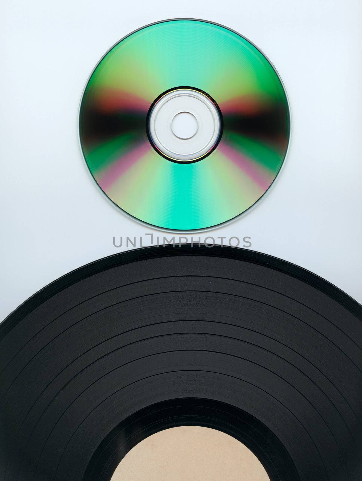 Close up of a cd and partial record over white