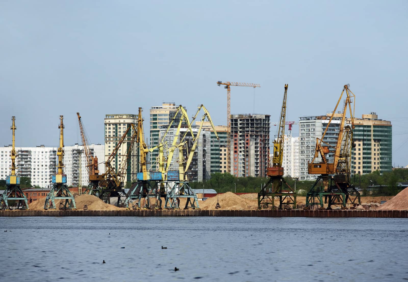 Machines on development of sand on a background of  buildings