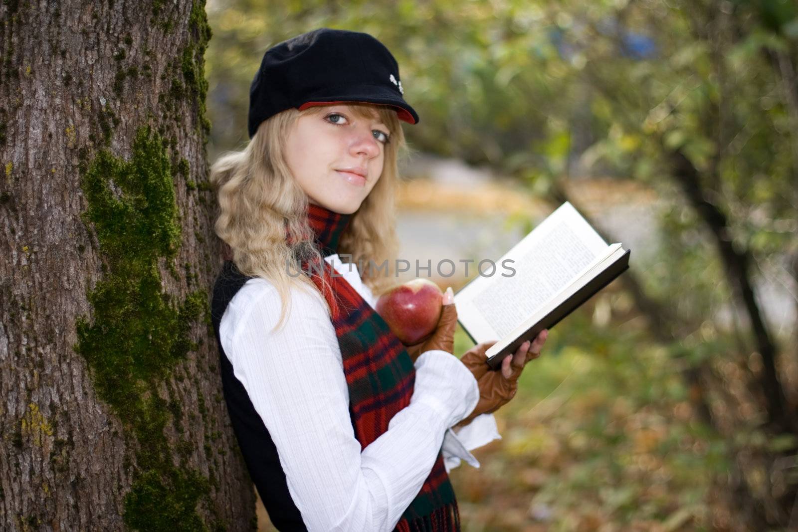 Student girl with a book in a hat by mihhailov